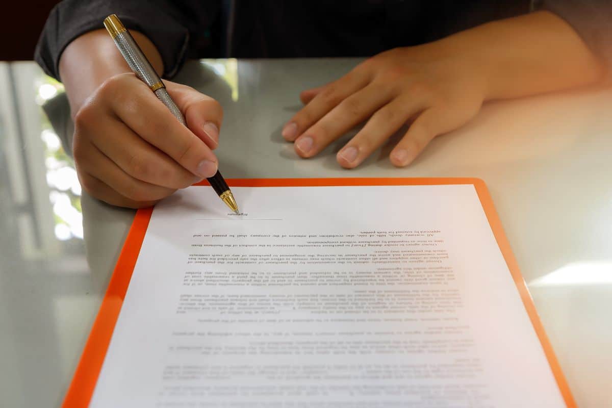 Close up of business man signing contract making a deal