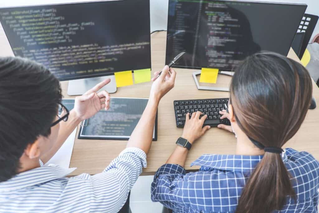High angle view of computer programmers coding in office