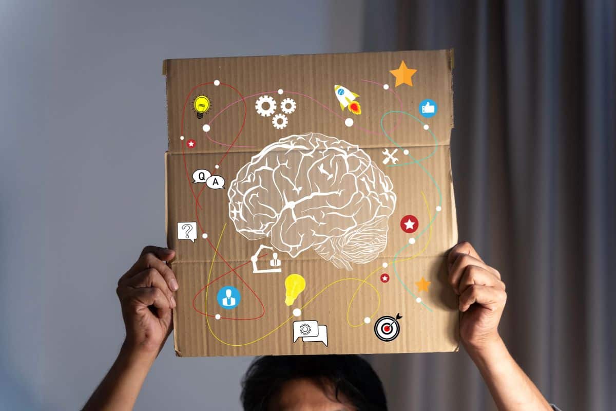 A businessman holds a piece of cardboard above his head