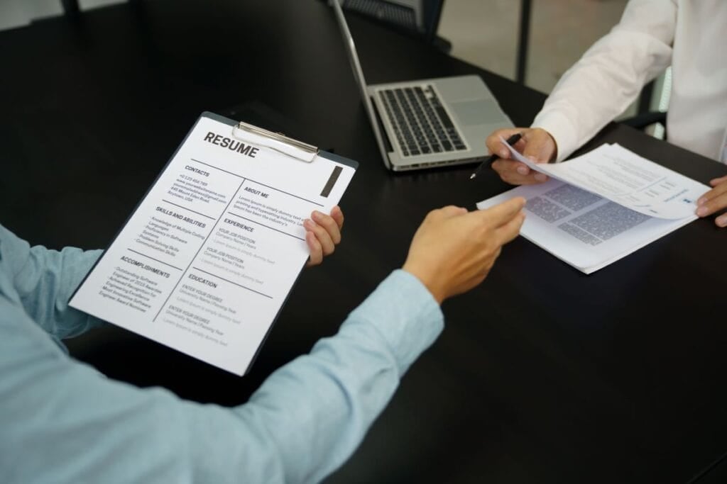 Examiner reading a resume during job interview at office business 