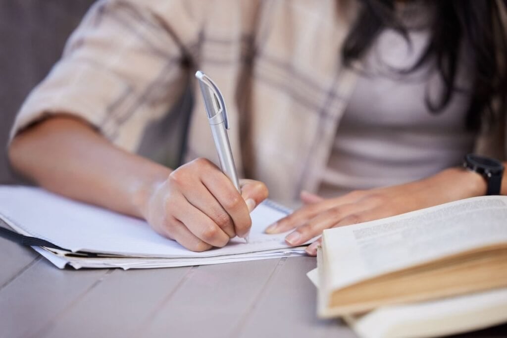 Notebook girl and hand with studying on table for education learning