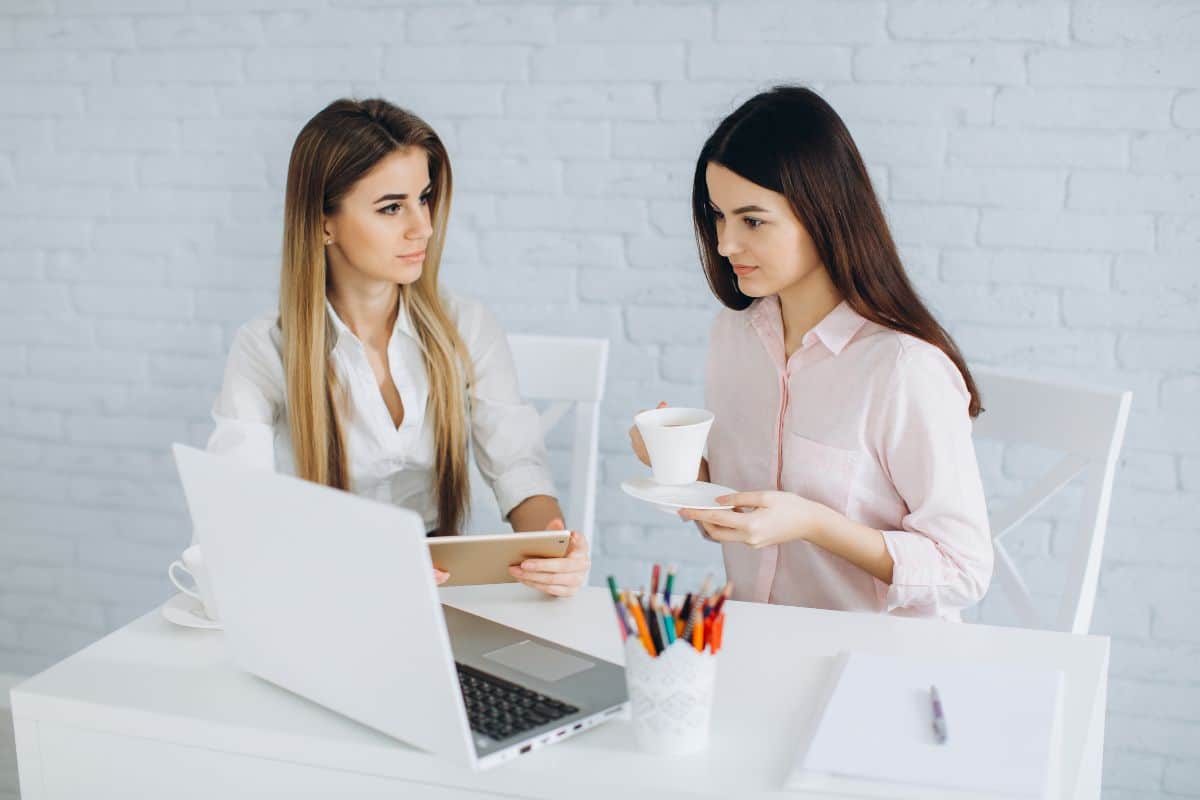Women with tablet in coffee
