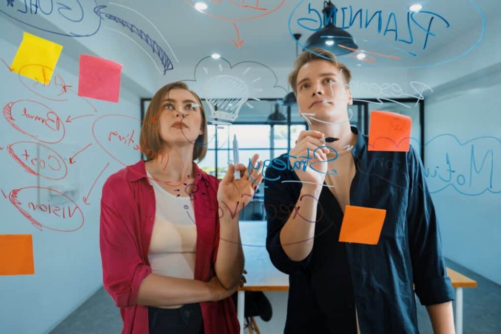 Couple of young creative start up business people brainstorming idea