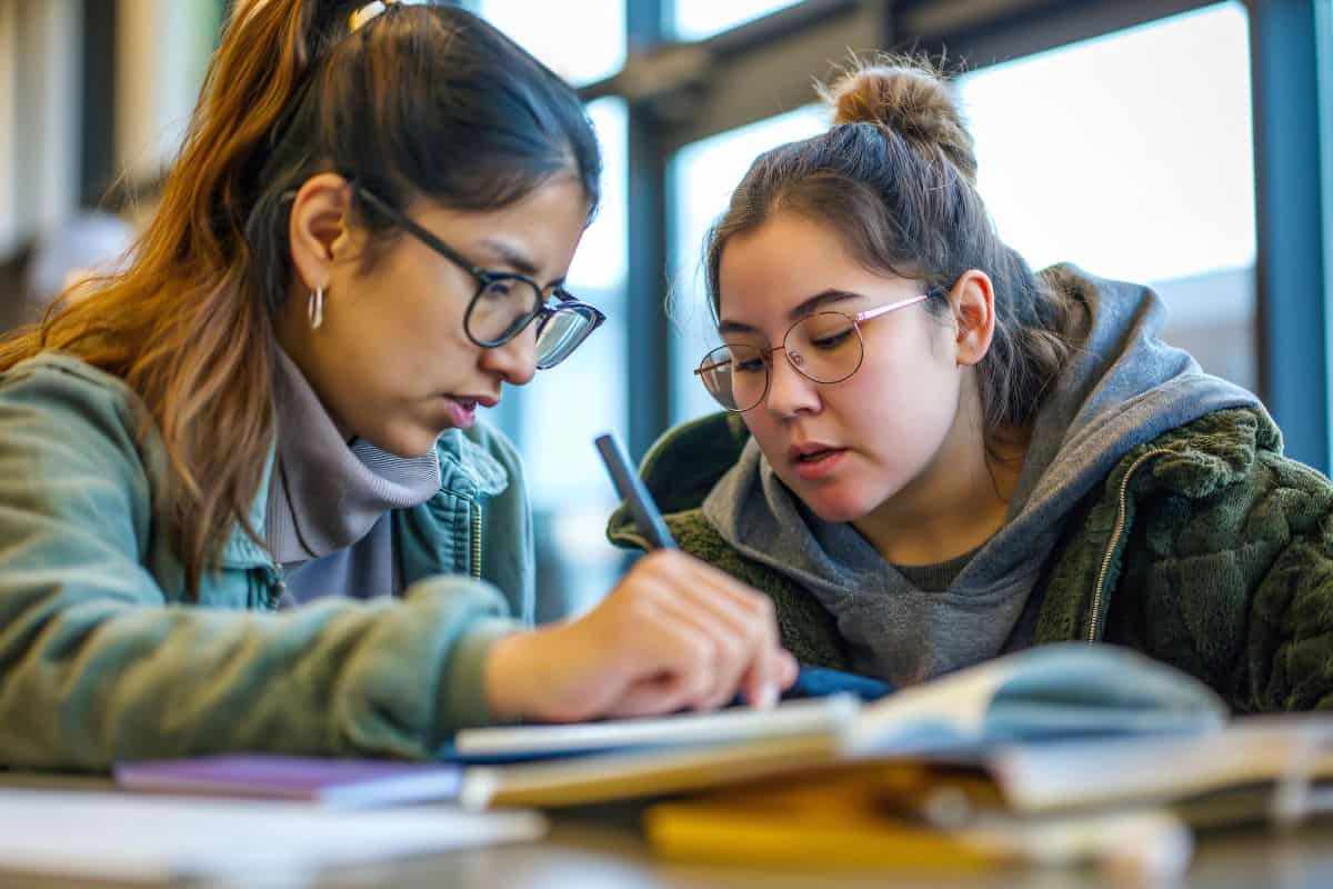 Two young women are working together in a university library