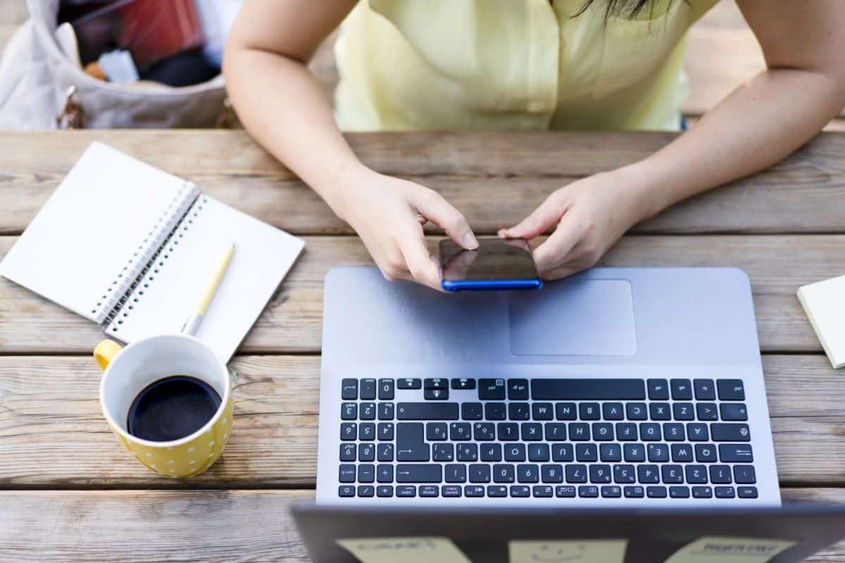 Young hipster woman typing and having fun