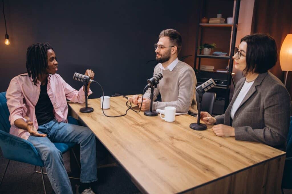 Professional radio team interviewing guest