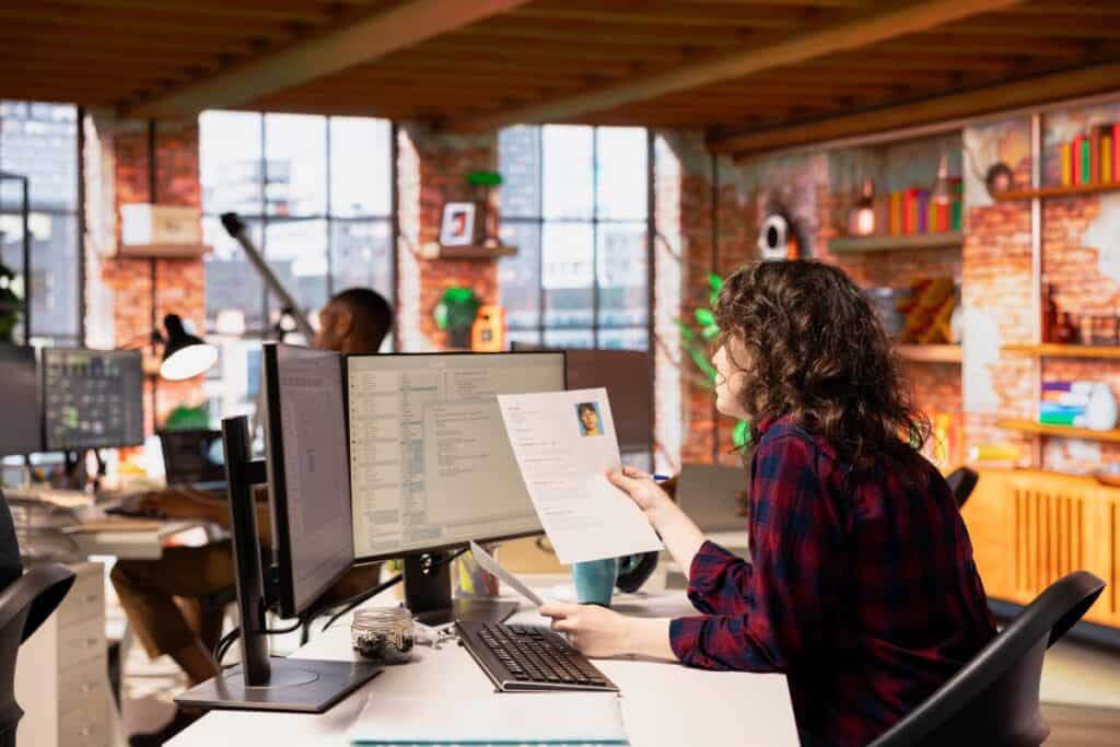 Startup hr employer reading cvs for software development position
