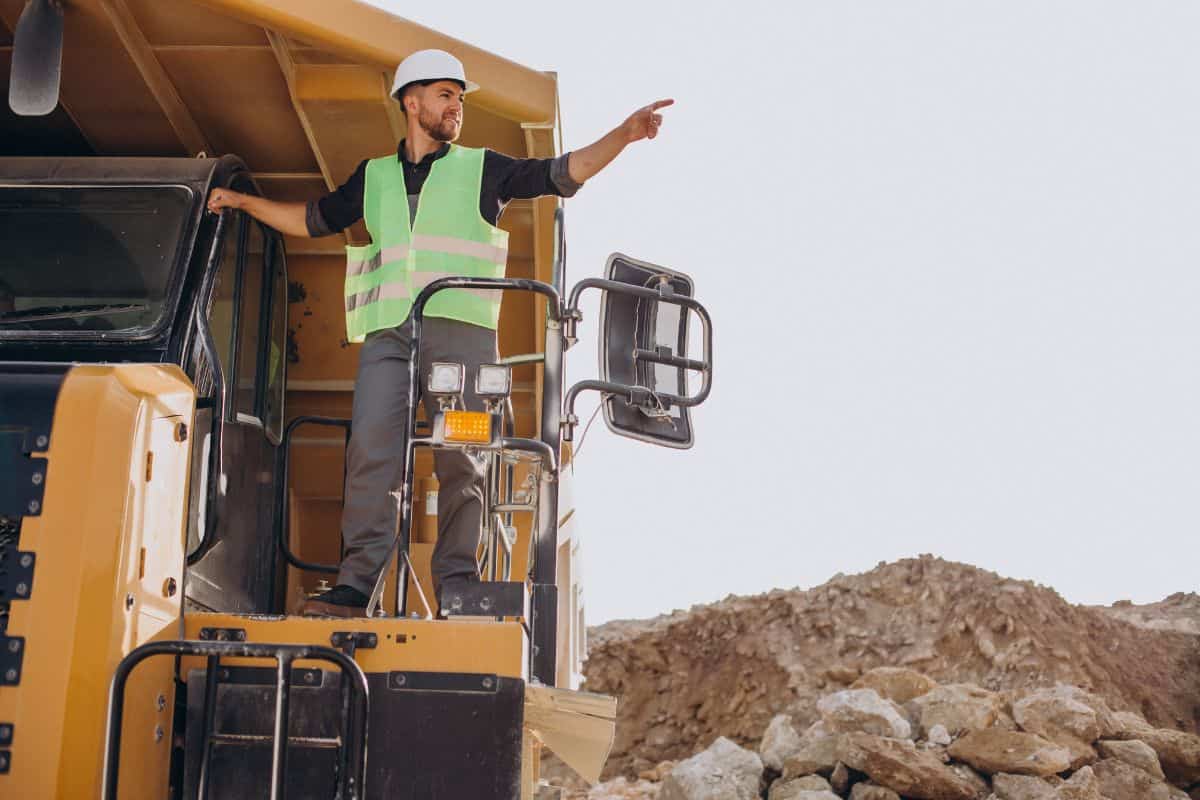Male worker with bulldozer in sand quarry