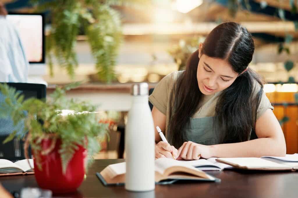Library writing notes and woman learning in university