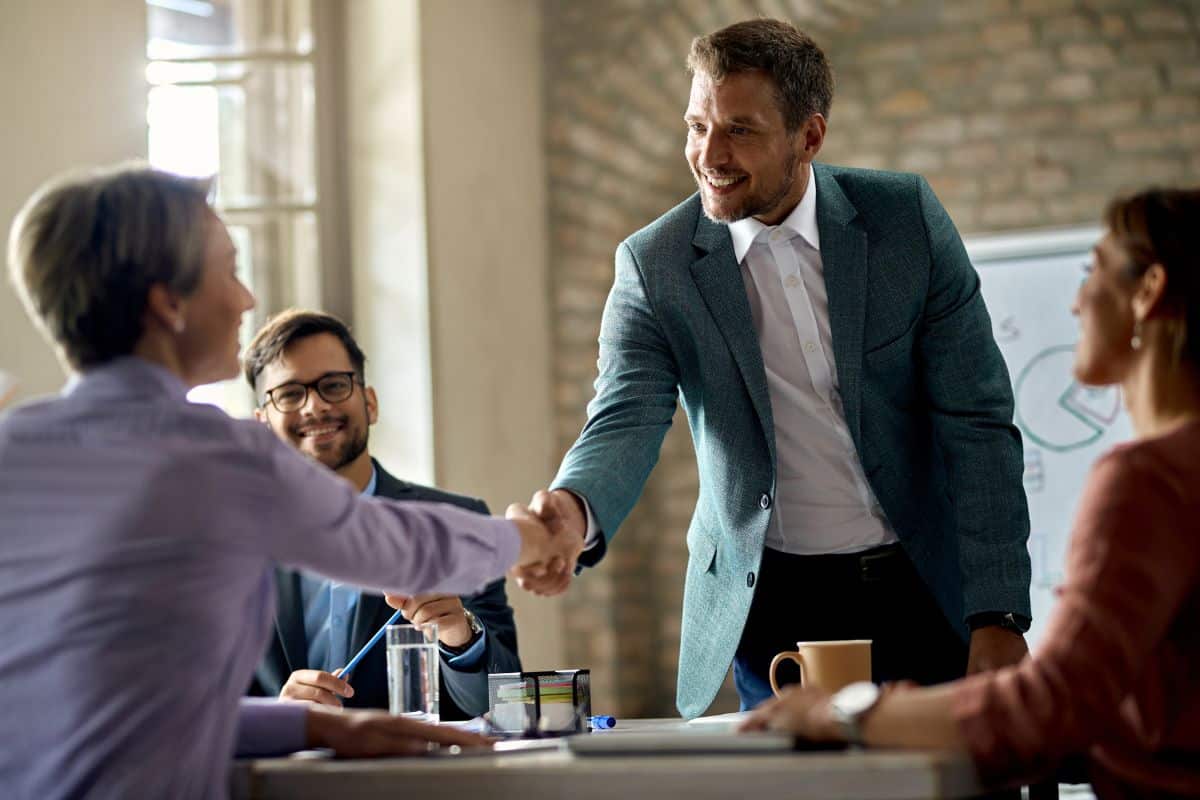 Business coworkers shaking hands during a meeting in the office