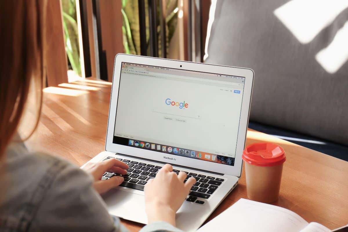 young woman using apple macbook air