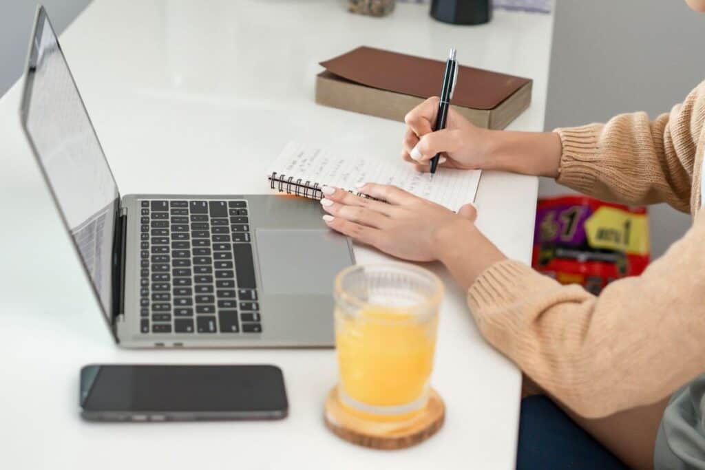 Happy young asian woman successful working with laptop