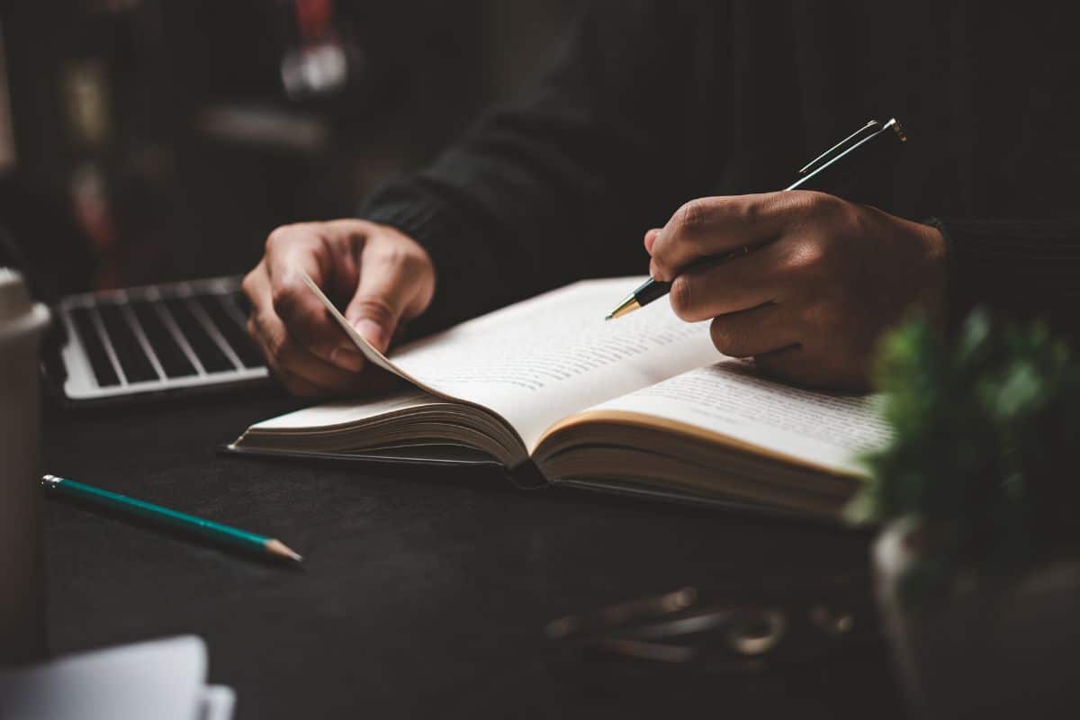 Businessperson reading and writing on bookeducation