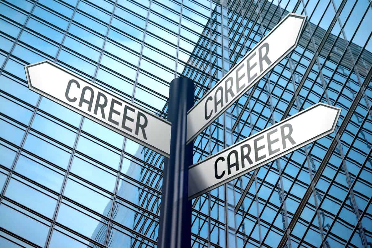 Career signpost with three arrows office building in background