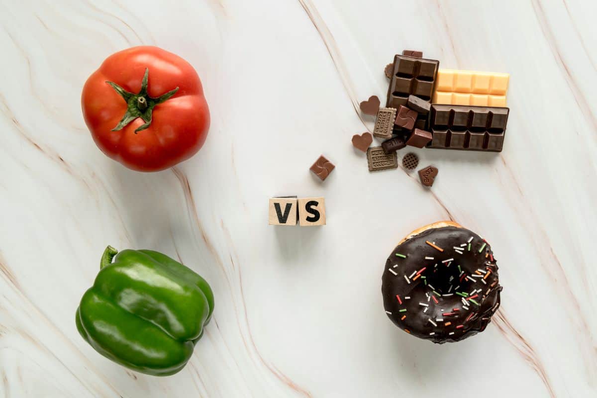 Healthy food vs unhealthy food concept over textured background