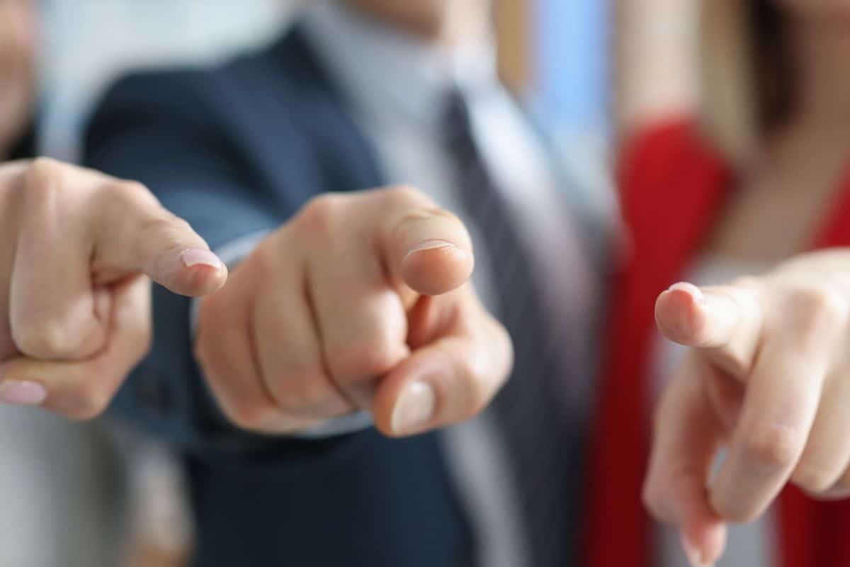 Successful business partners pointing finger in front of them