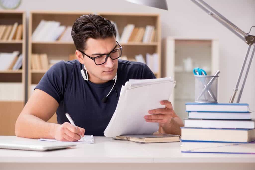 Happy male student preparing for his exams