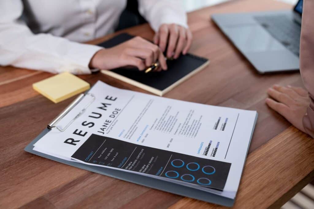 Closeup resume paper with qualifications on desk during interview