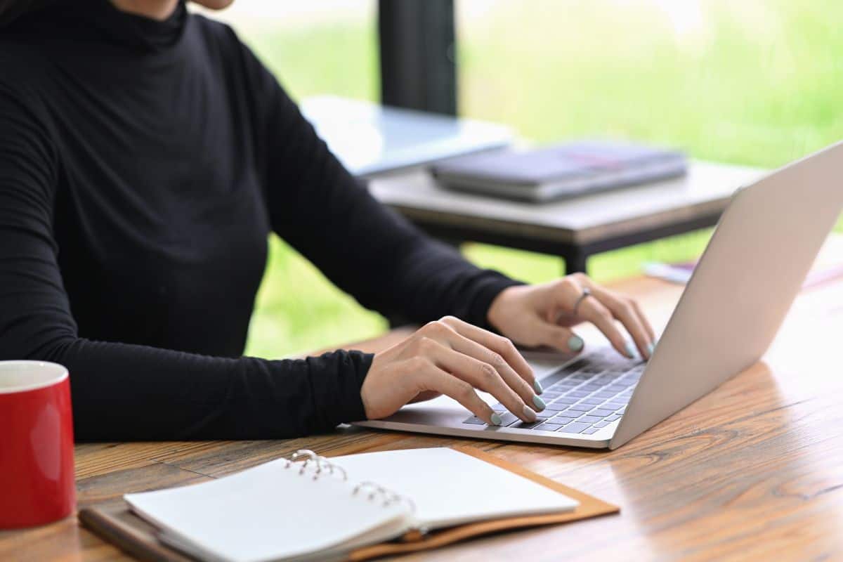 Cropped shot stylish woman working with laptop computer