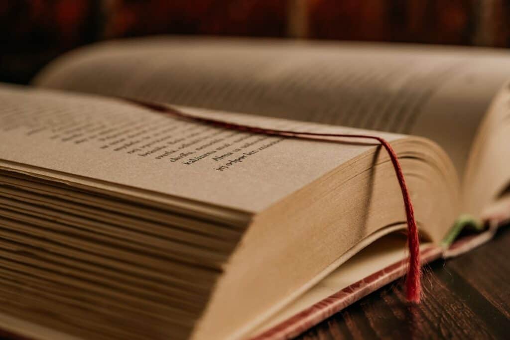
Opened book on a pile of old books study education concept