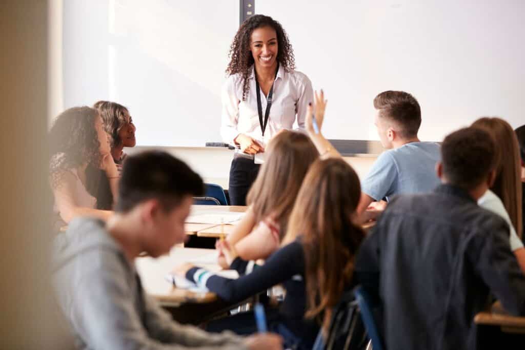 Female high school teacher standing in front of interactive