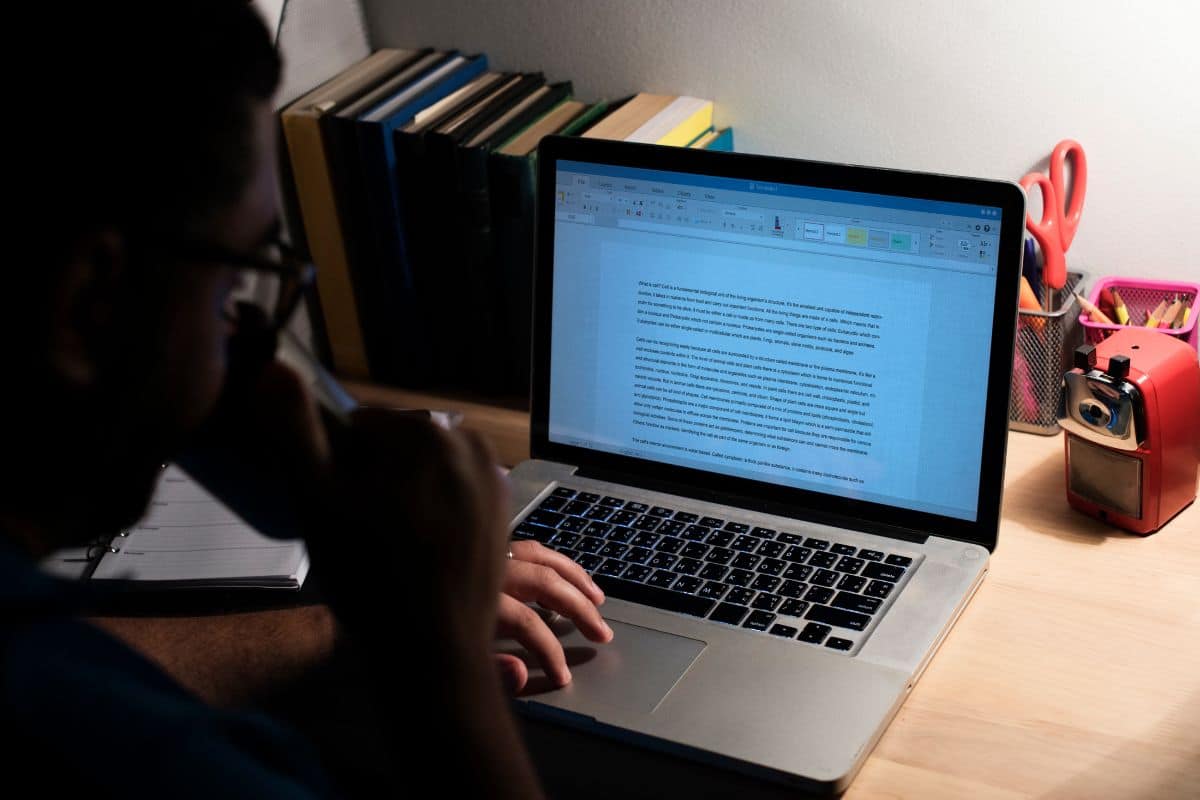 Man working in a home office with a laptop