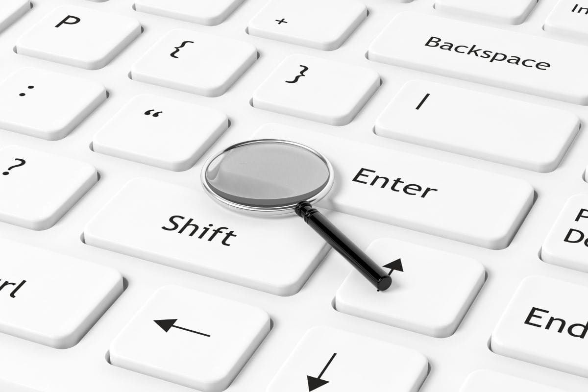 Computer keyboard closeup with magnifier on enter key