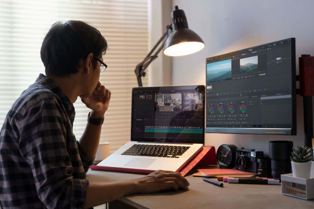 Male freelancer editing video on computer with professional program