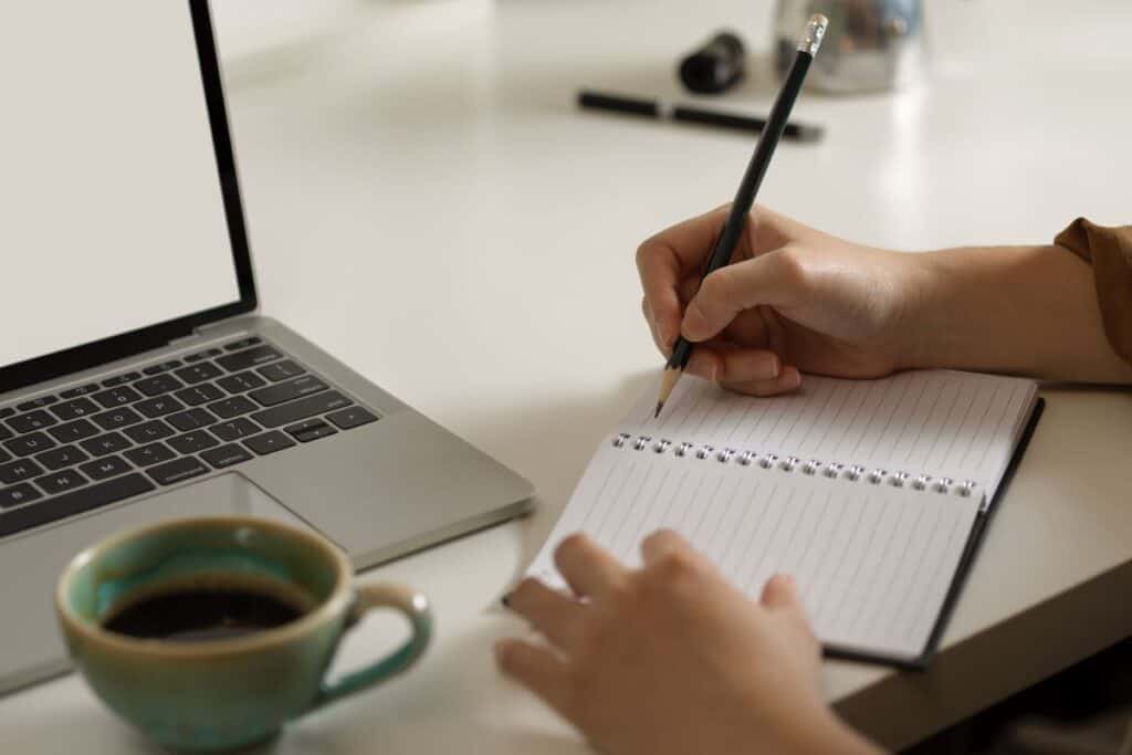 Female taking note on blank notebook