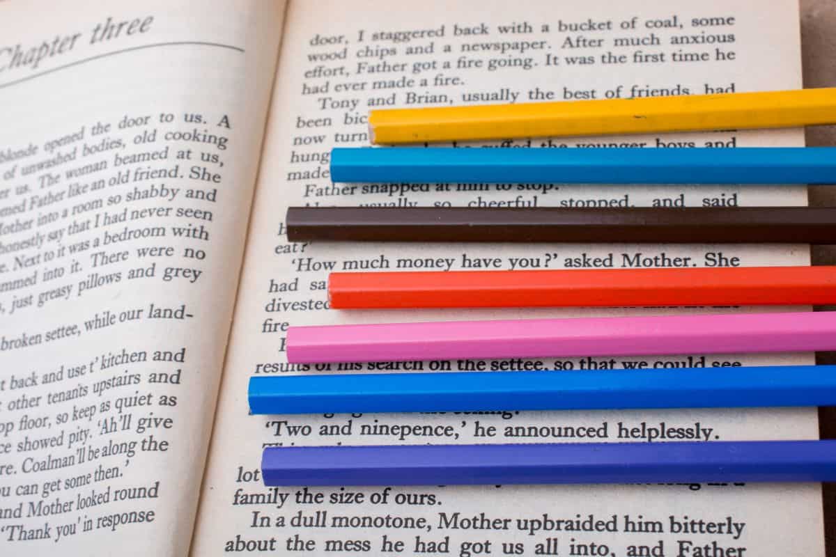 Color pencils placed on the page of a book