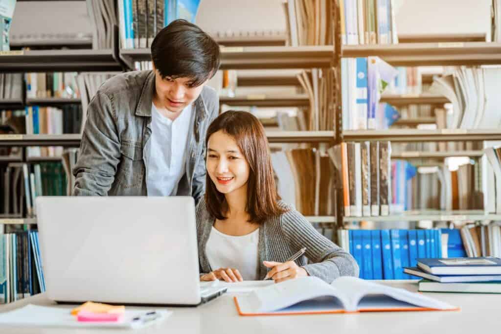 Two students are reading and discussing about exam preparation
