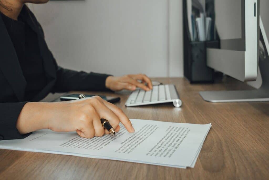Businesswoman checking text and typing with modern computer