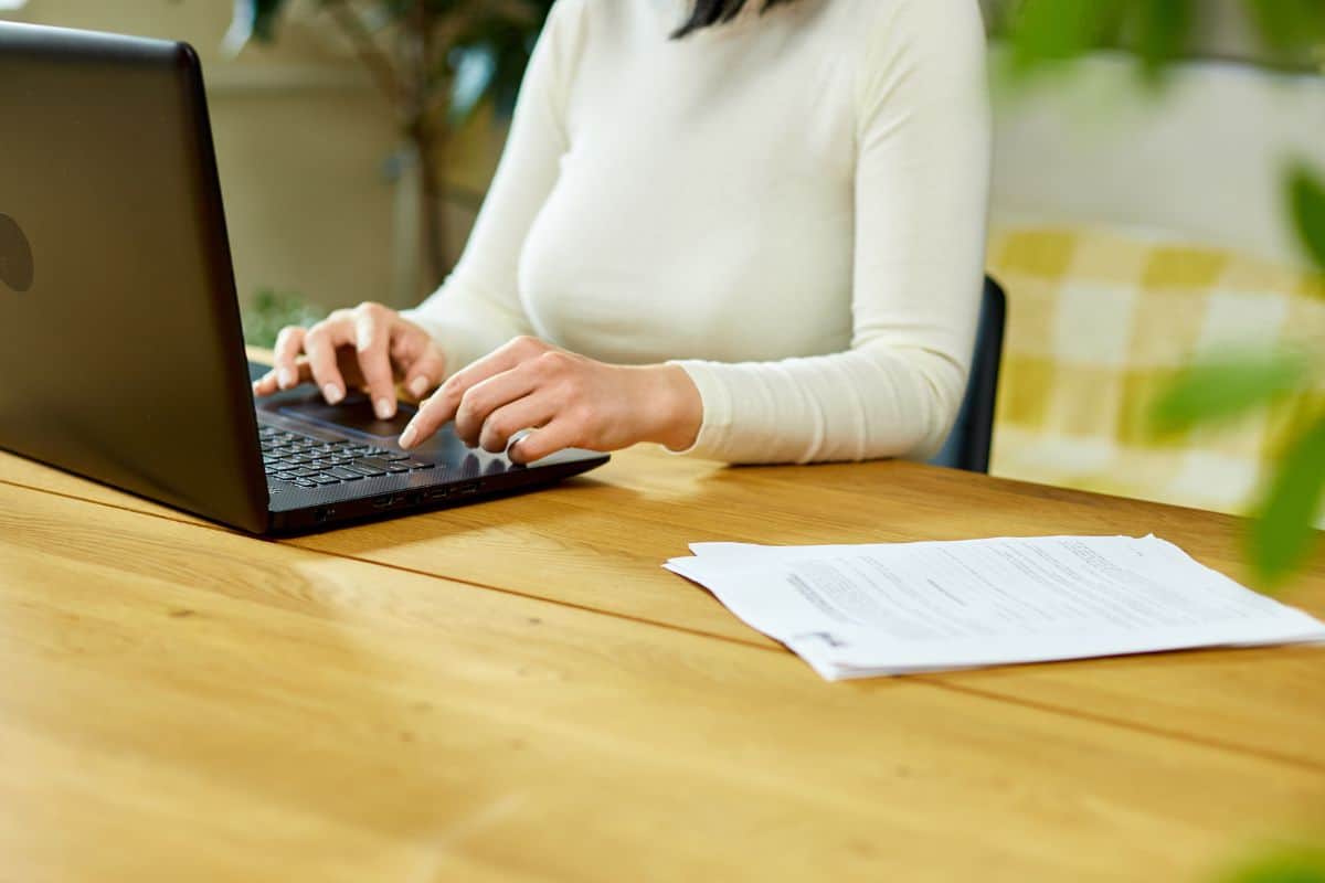 Unrecognizable hand freelancer woman working with laptop