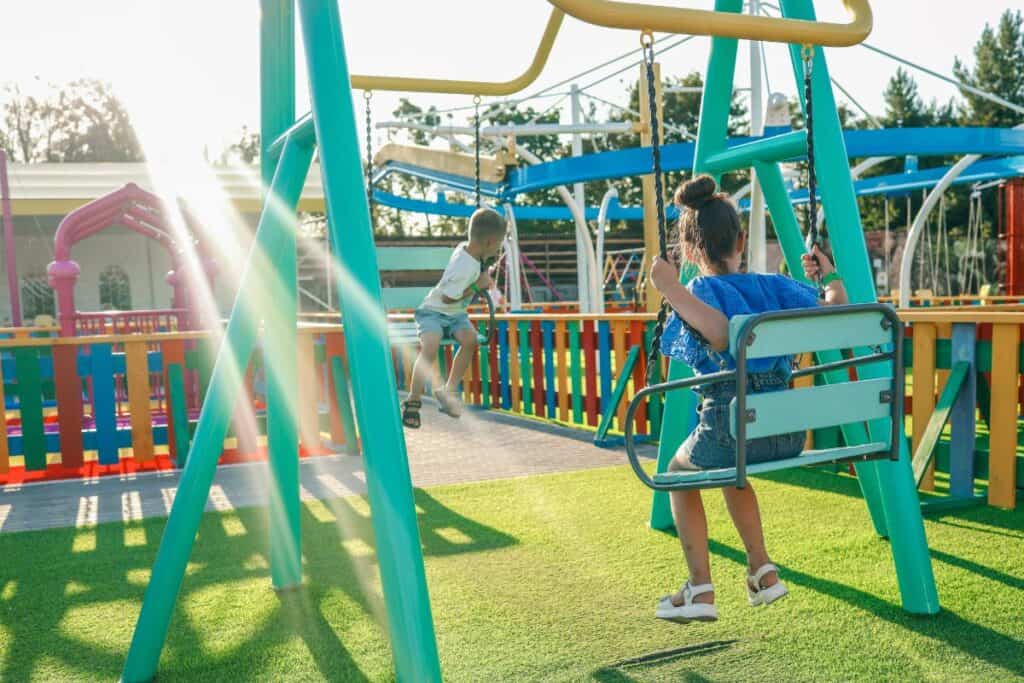Children playing on colorful swings