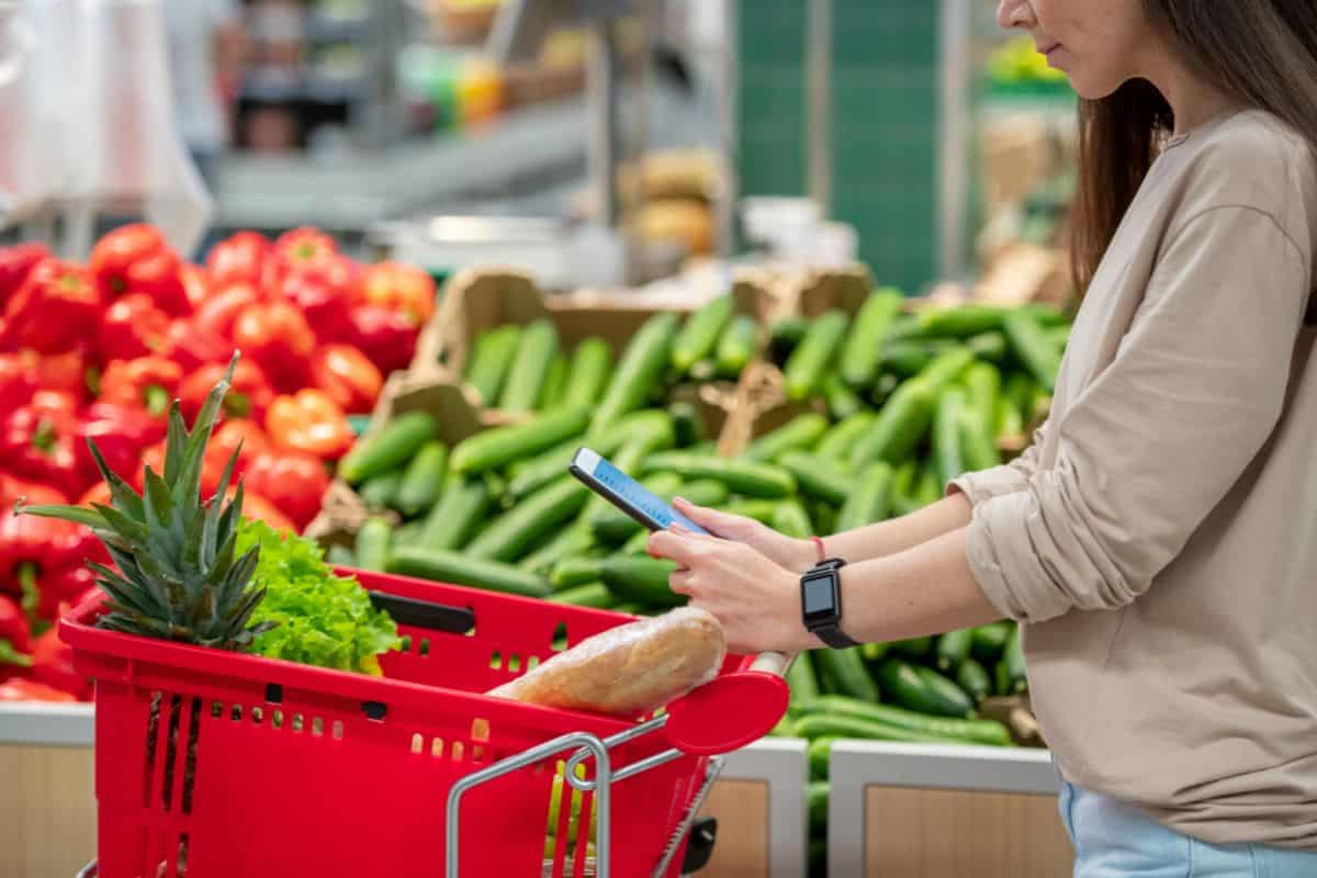 Portrait of young adult woman standing in supermarket