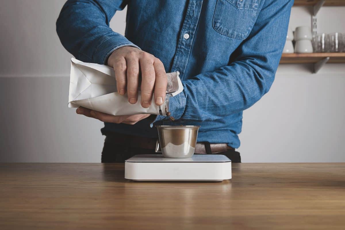 Step by step aero press coffee preparation barista in blue jeans shirt