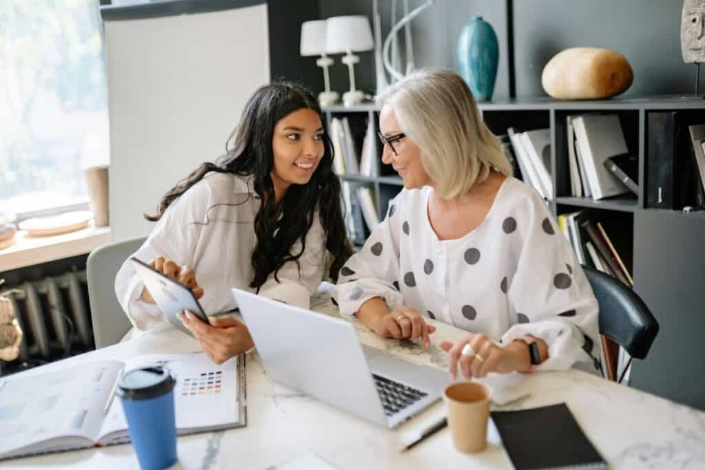 Women Sitting at the Meeting Table with Laptop and Digital Tablet