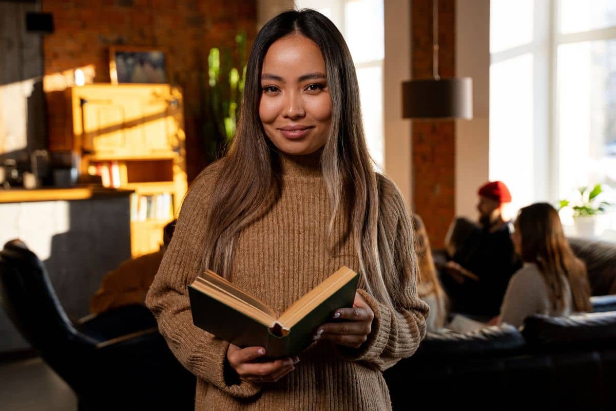 Front view smiley woman holding book