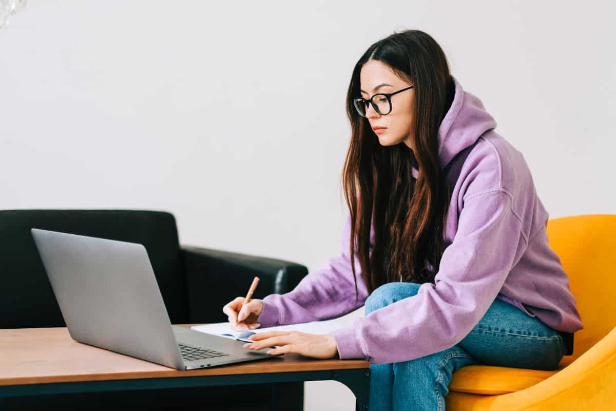 Focused caucasian young woman college student in eyeglasses