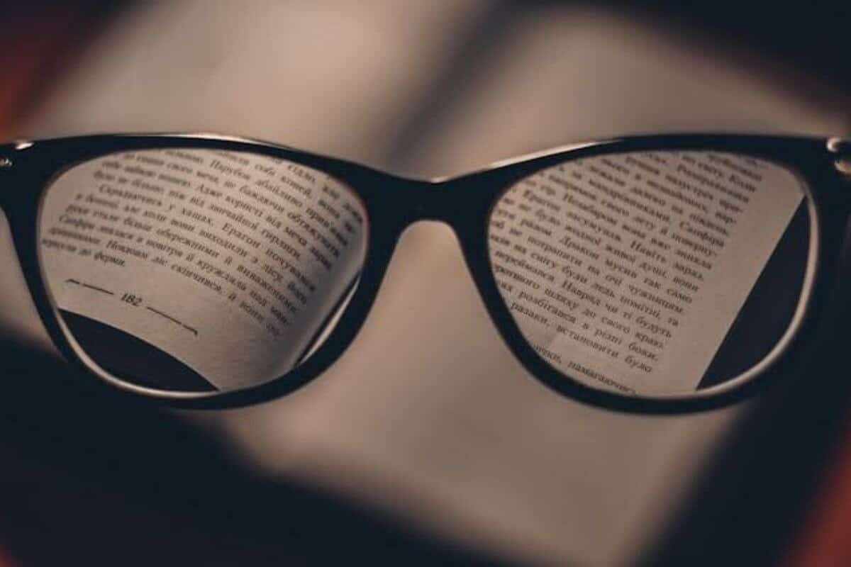 Eyeglasses placed on an open book.
