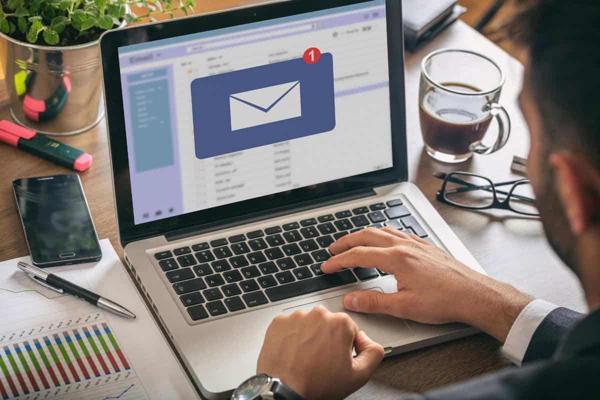 Email message inbox notification on laptop screen business background