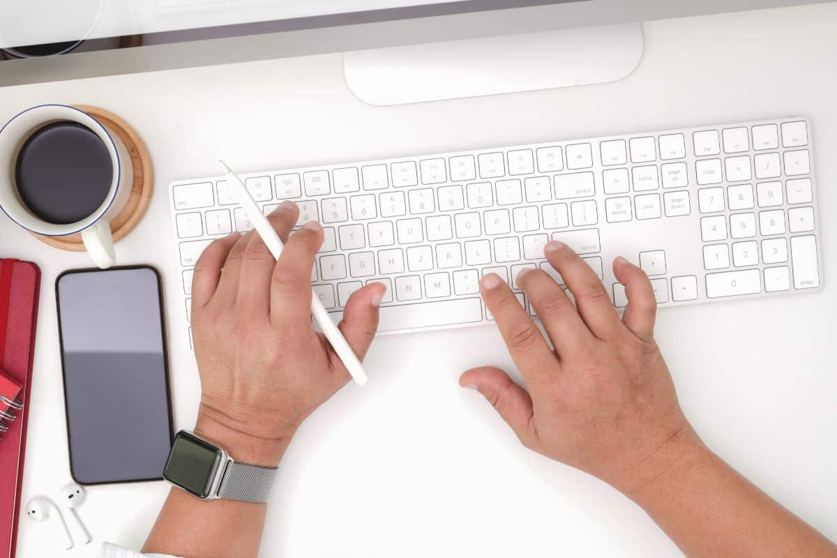 Top view of young businessman typing on keyboard computer
