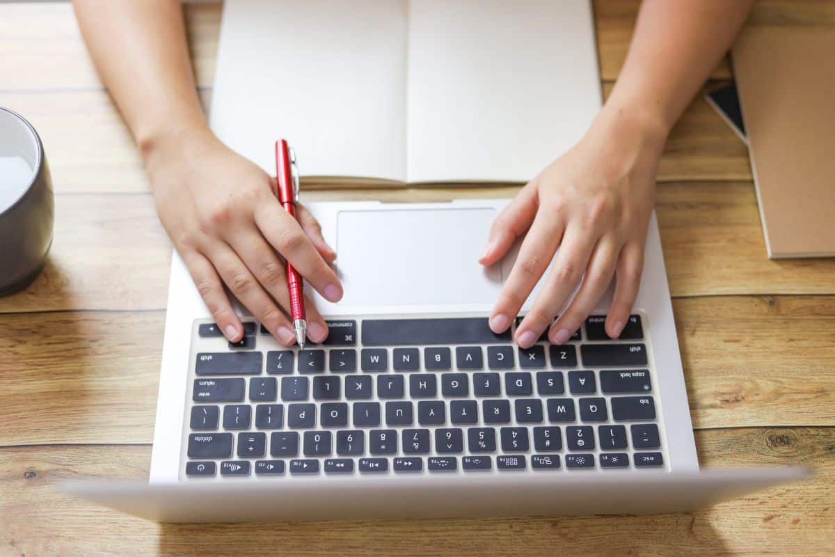 Midsection of woman using mobile phone on table