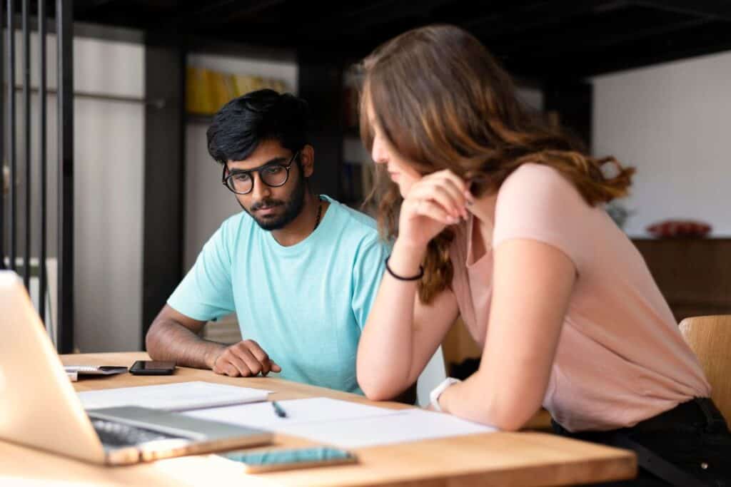 College girl and boy studying together