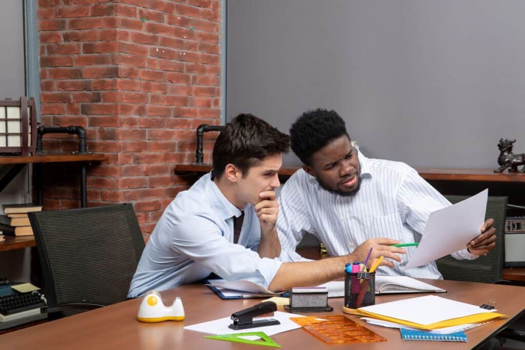 Front view two businessmen satisfying working together