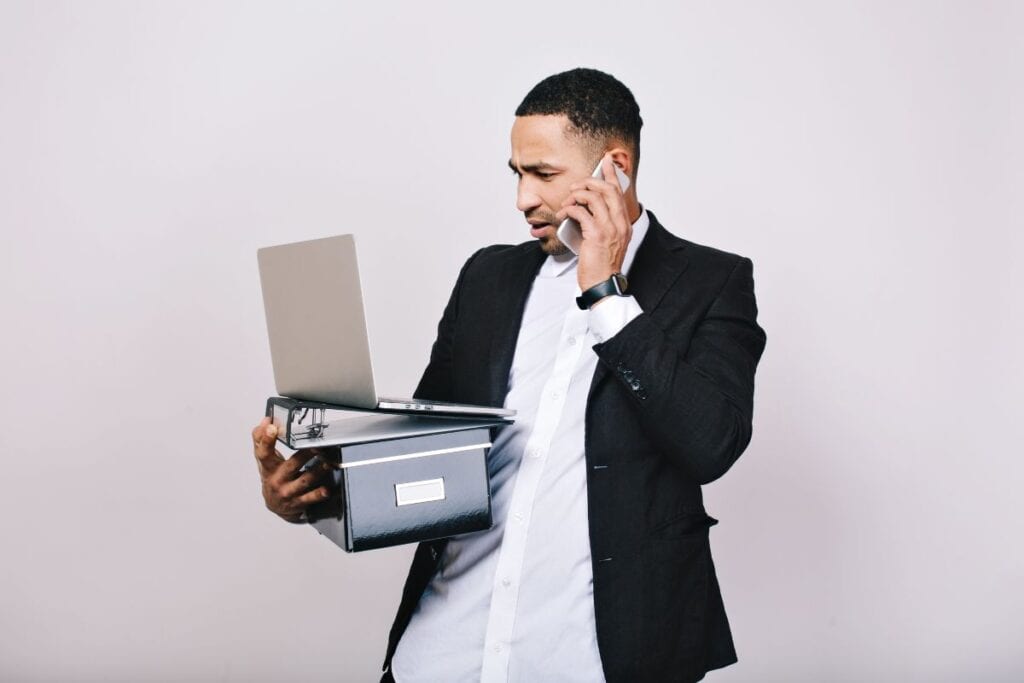Hard-working astonished businessman with office box