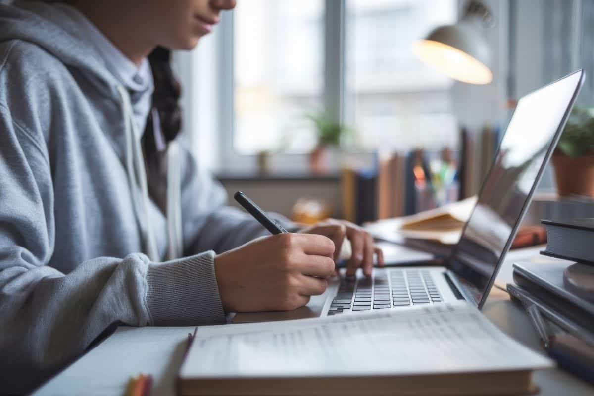 College student completes homework with laptop