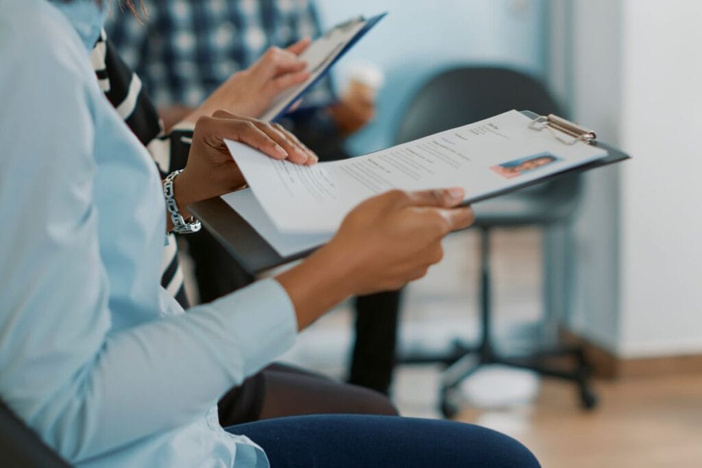 Female candidate sitting in queue and receiving cv files,