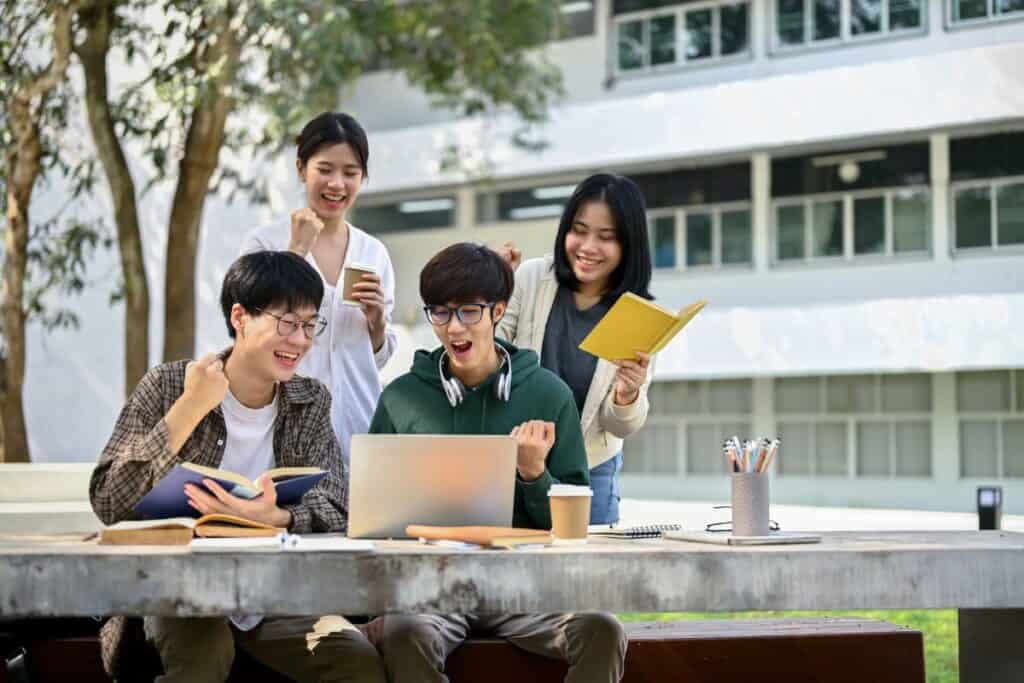 Group off cheerful young asian college students celebrating