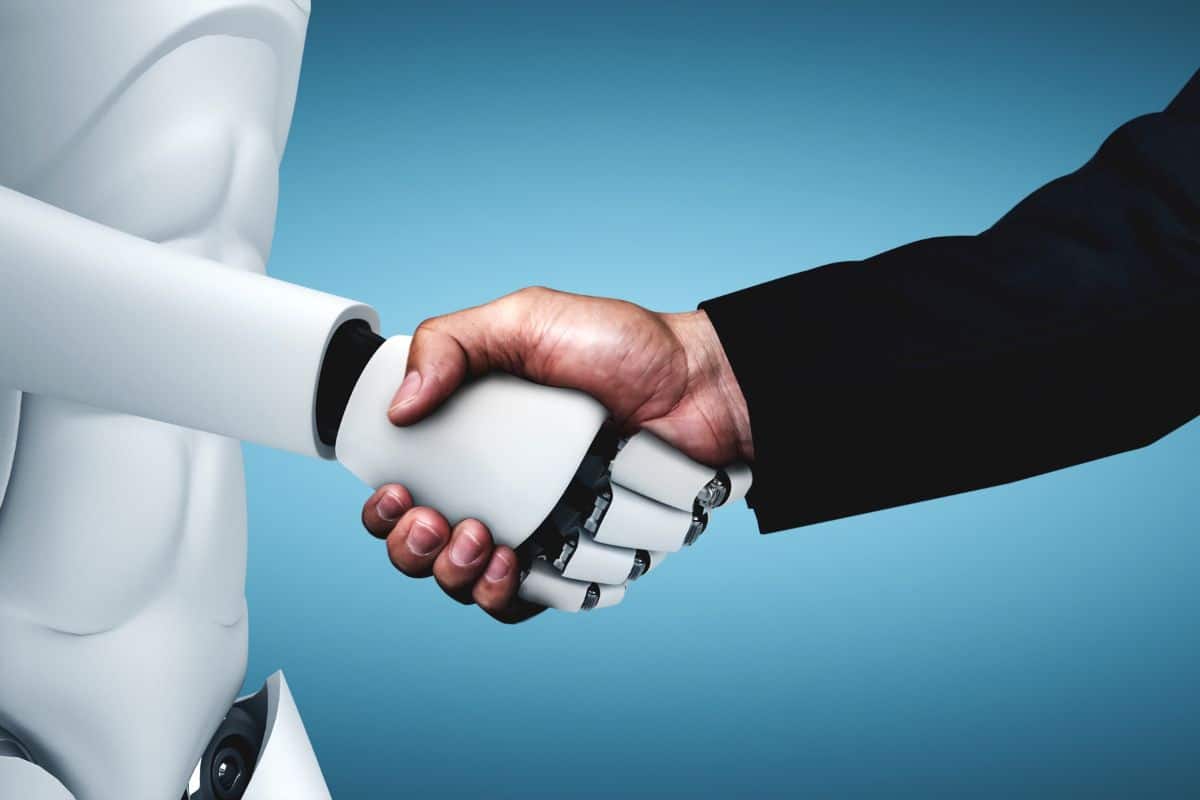 Humanoid robot shaking hands with a man